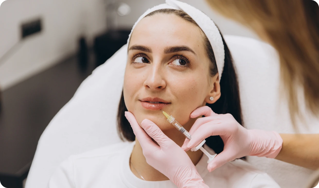Woman receiving cosmetic injection in clinic.